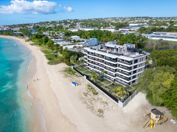 Aerial shot of luxury beachfront apartments in Barbados along the white sand shoreline