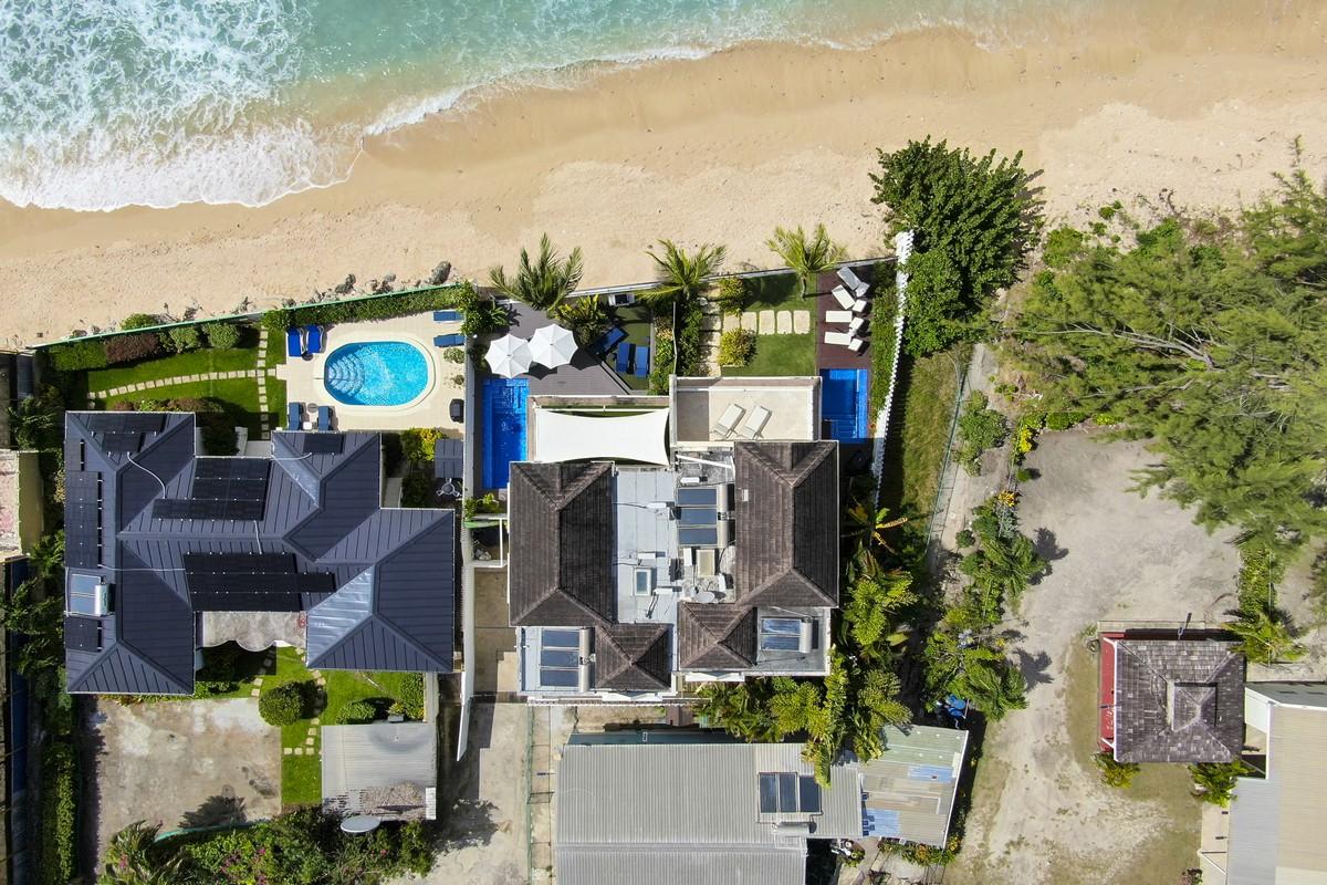 Drone view of Barbados beachfront villa with plunge pool and lounge garden steps from the sea