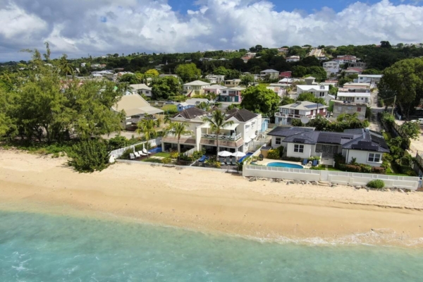 Beachfront Barbados villa with plunge pool and neighboring homes near the shoreline