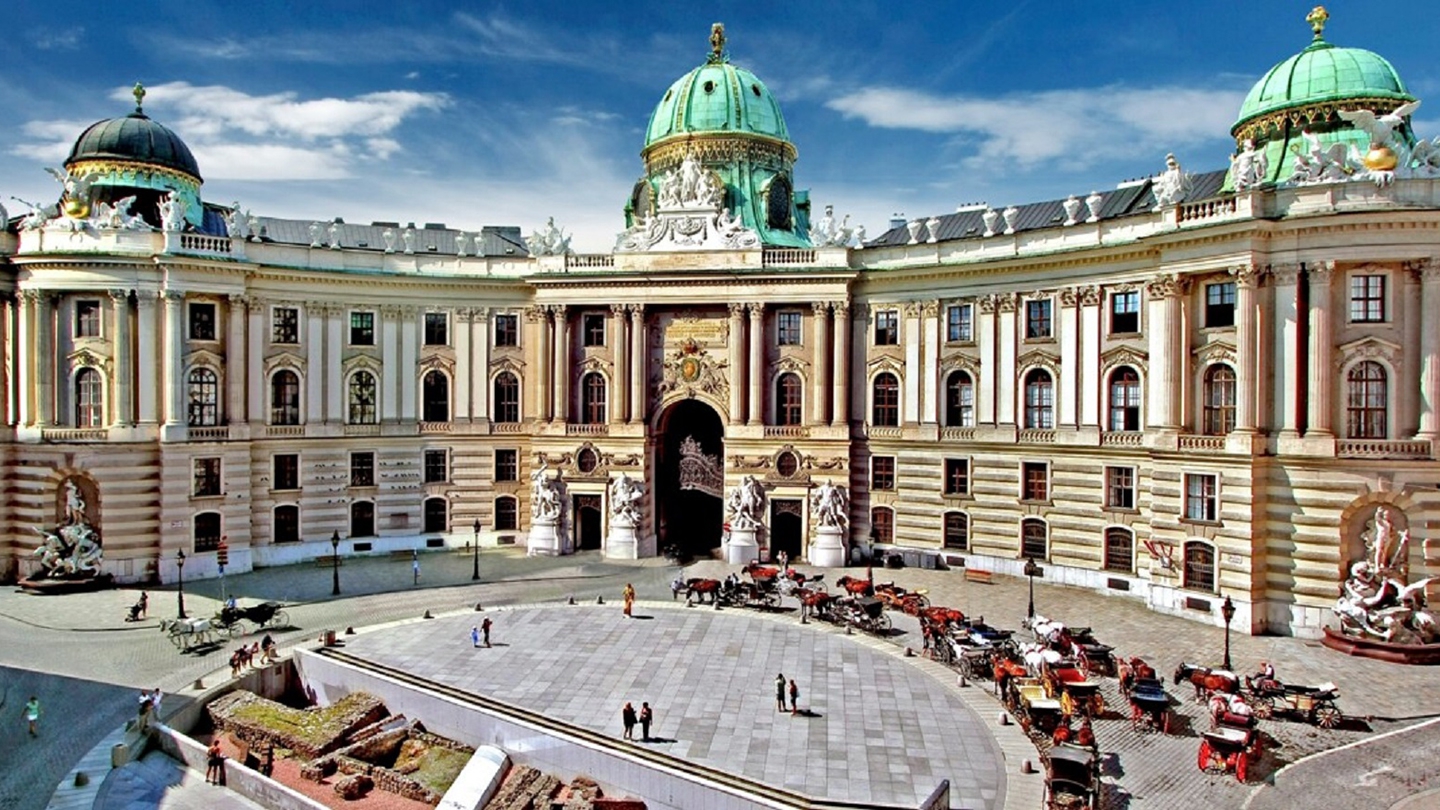 The grandeur of the Hofburg Palace in Vienna, Austria, with its iconic green domes and historic architecture.